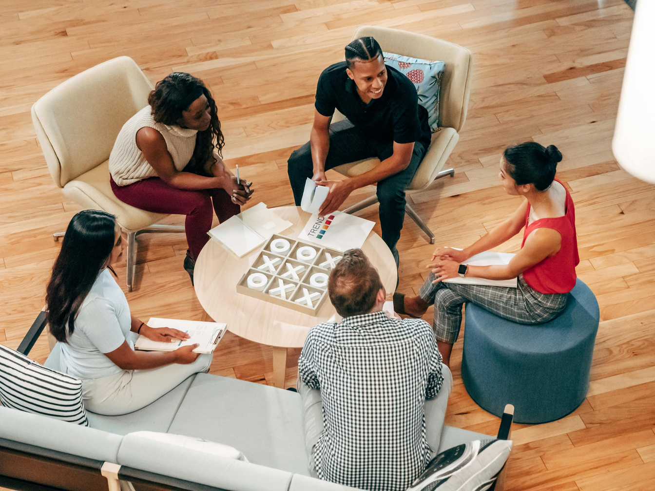 a group of people sitting around a table playing a board game