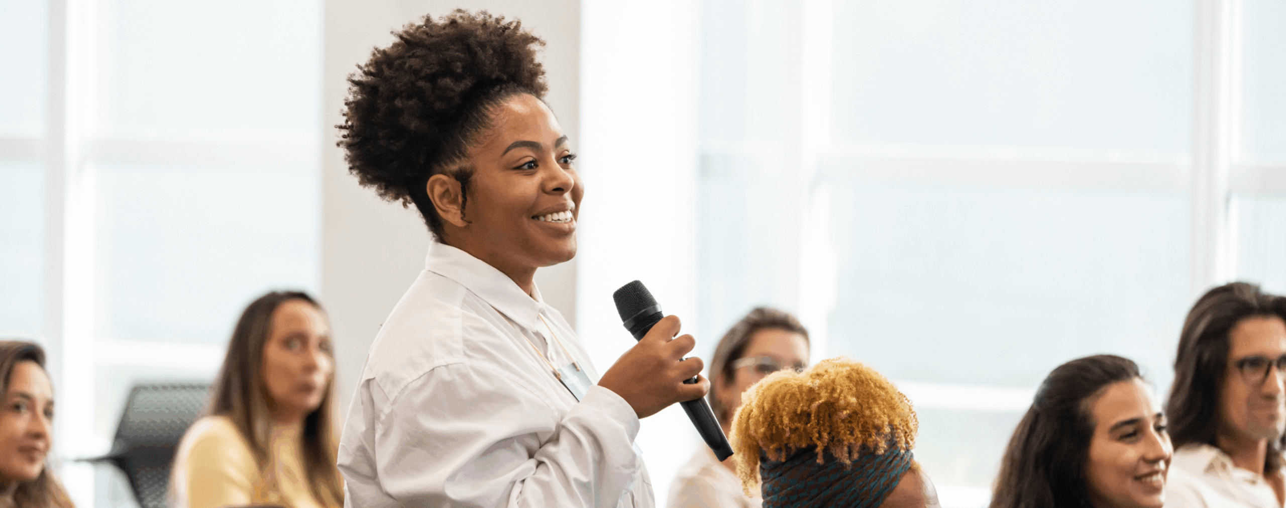 black woman speaking on mic scaled